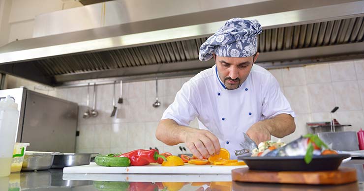 A chef preparing fruits