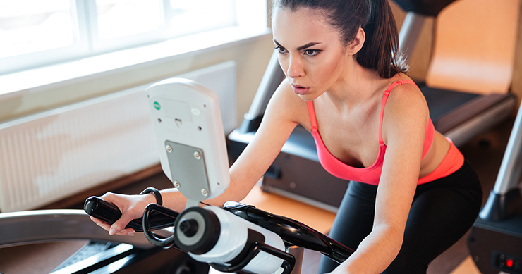 fit girl working out using the eliptical machine