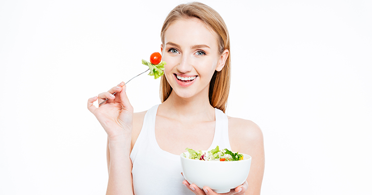 girl holding a salad bowl with white background