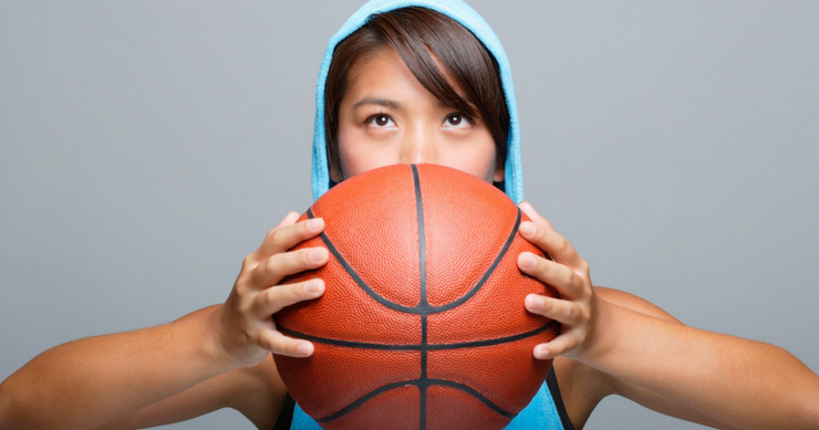 Fit Girl wearing Hoodie Jersey and holding a basketball